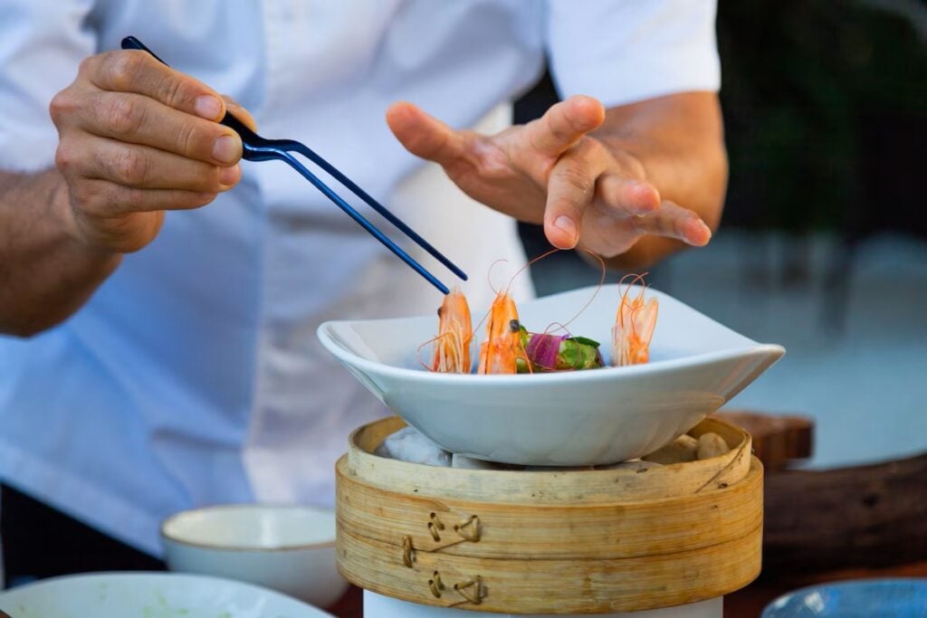 A chef prepares a shrimp dish at a restaurant at the Paradisus Playa del Carmen all-inclusive resort in Mexico.